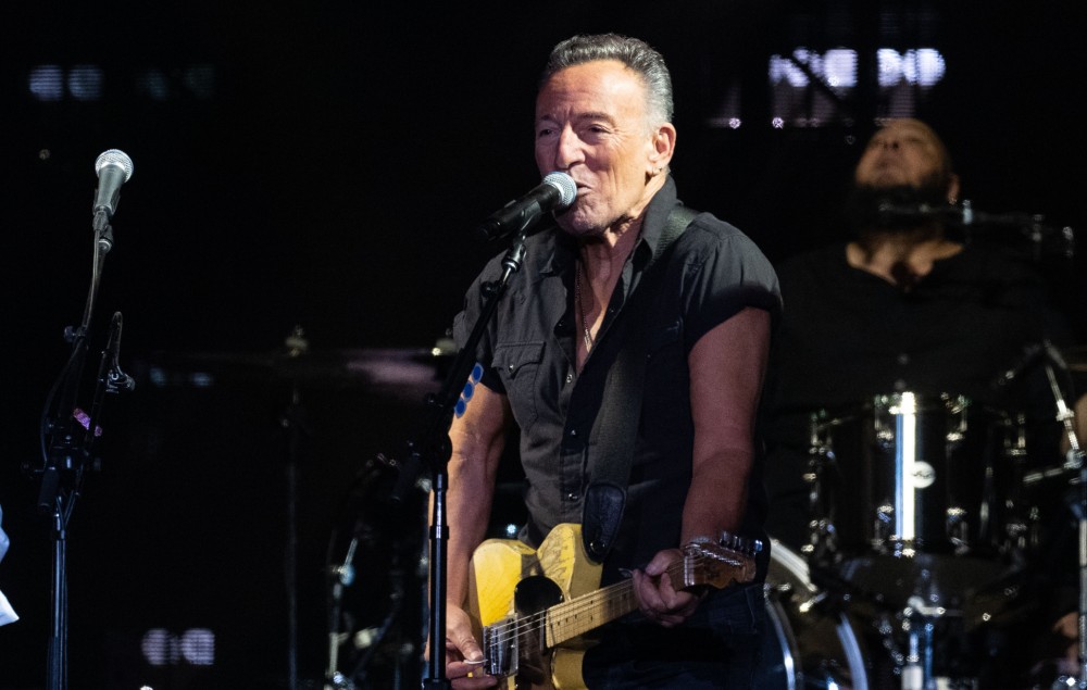 Bruce Springsteen performing live on stage during Paul McCartney's headline set at Glastonbury 2022