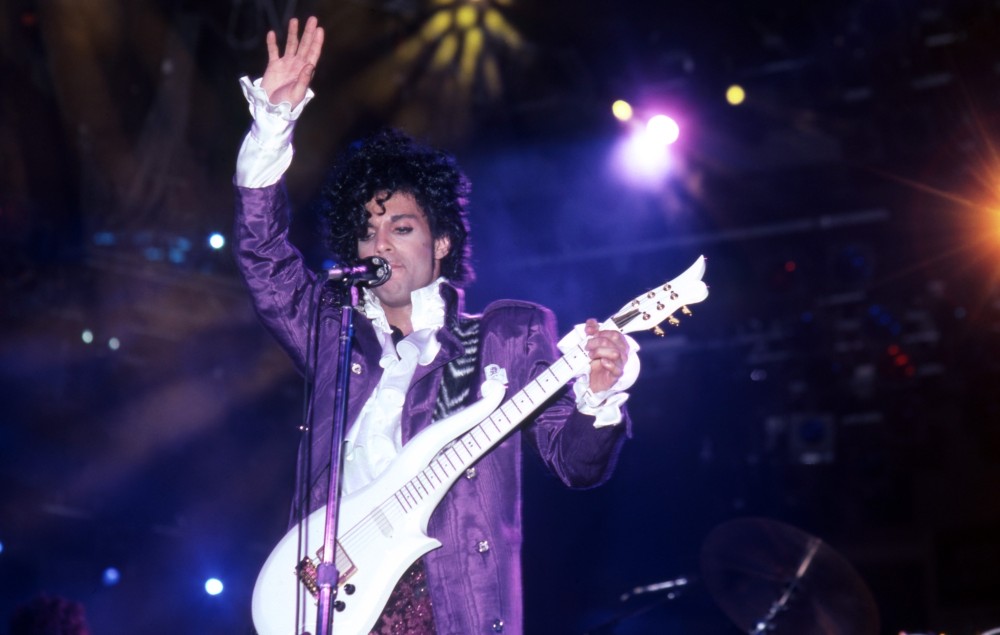 Prince performing live onstage during his 'Purple Rain' tour in 1984