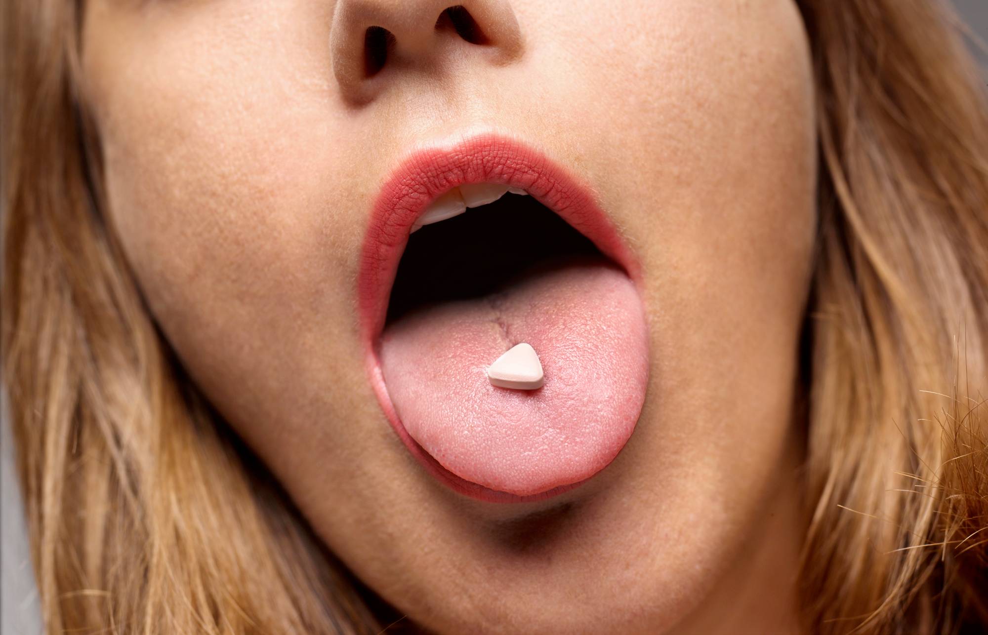 Girl with recreation drug on tongue. Credit: GETTY