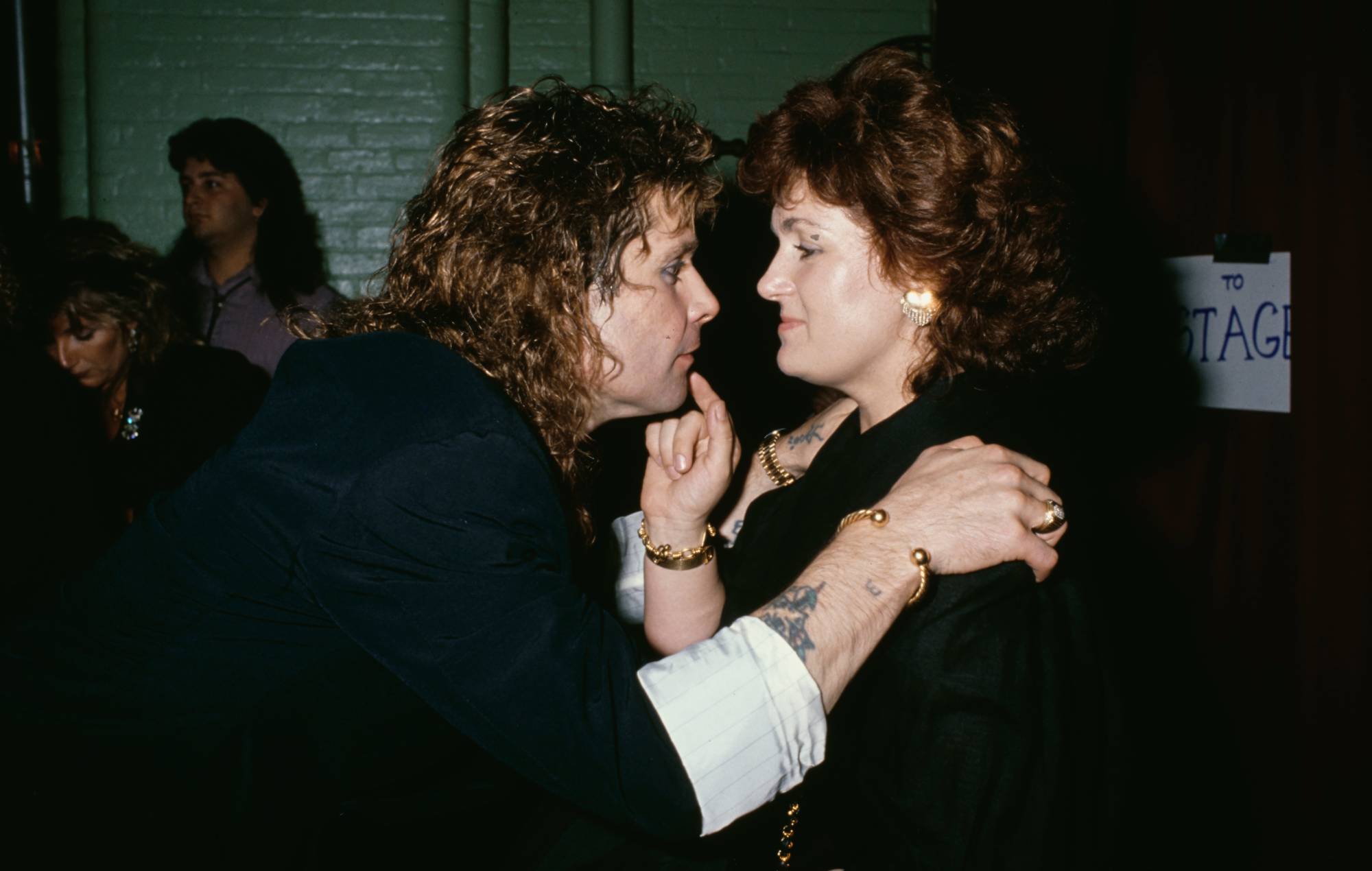 Ozzy Osbourne goes face-to-face with his British manager and wife, Sharon Osbourne, his hands on her shoulders at an event, circa 1985 (Photo by Vinnie Zuffante/Michael Ochs Archives/Getty Images)