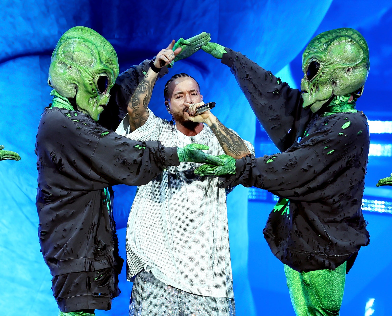J Balvin performs between two green aliens