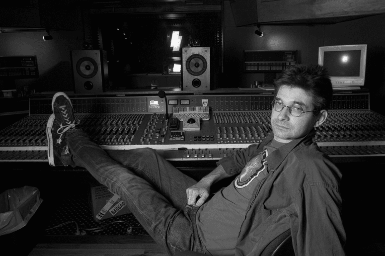 Steve Albini sitting in a studio with his feet propped up on the mixing board