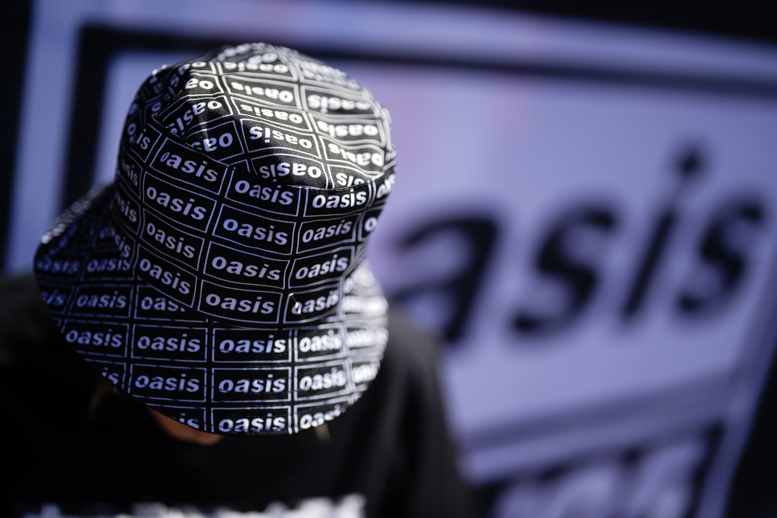 An Oasis fan wears a bucket hat