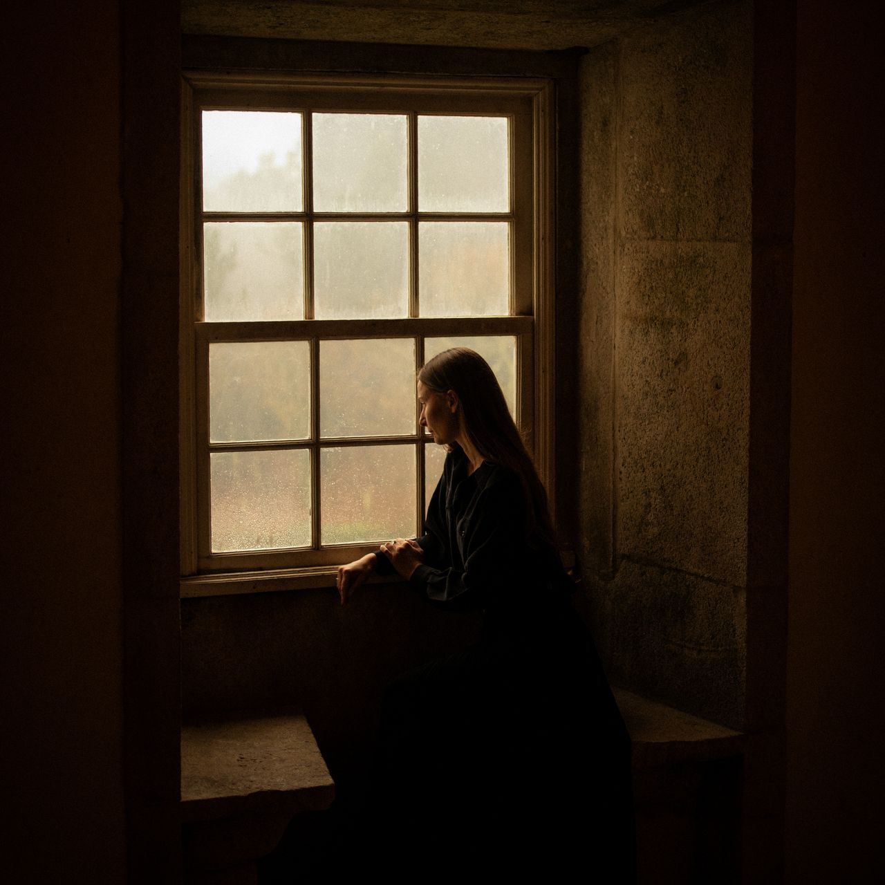 Image may contain: Adult, Person, Window, and Windowsill