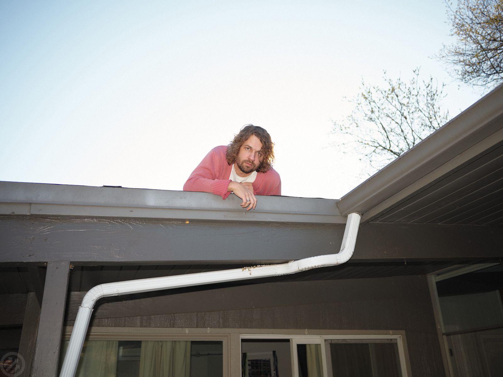 Image may contain Architecture Building House Housing Roof Adult Person Face Head and Gutter